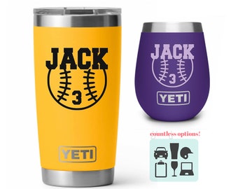 May include: A yellow Yeti tumbler with a black baseball and the name "JACK" and the number "3" on it. The tumbler has a silver lid and base. A purple Yeti wine tumbler with a black baseball and the name "JACK" and the number "3" on it. The tumbler has a silver lid and base.