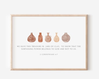May include: A framed print featuring watercolor illustrations of six earthenware vases in shades of brown and beige. The print includes the text "WE HAVE THIS TREASURE IN JARS OF CLAY..." and "2 CORINTHIANS 4:7". The frame is a light wood color.