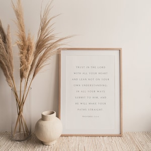 May include: A framed print with a white background and black text. The text reads "Trust in the Lord with all your heart and lean not on your own understanding: In all your ways submit to him, and he will make your paths straight. Proverbs 3:5-6".