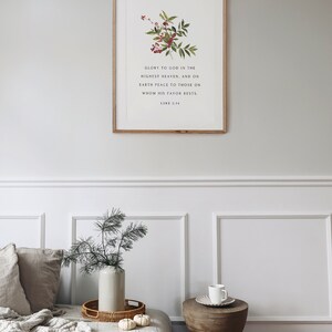 May include: A framed print with a floral illustration and a bible verse: "Glory to God in the highest heaven, and on earth peace to those on whom his favor rests. Luke 2:14"