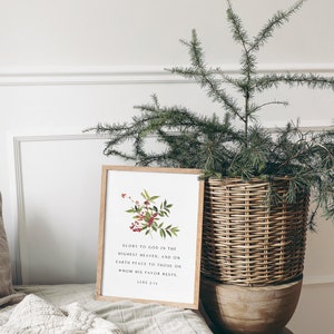 May include: A framed print with a watercolor illustration of a red berry branch and the text "Glory to God in the highest heaven, and on earth peace to those on whom his favor rests."  Luke 2:14