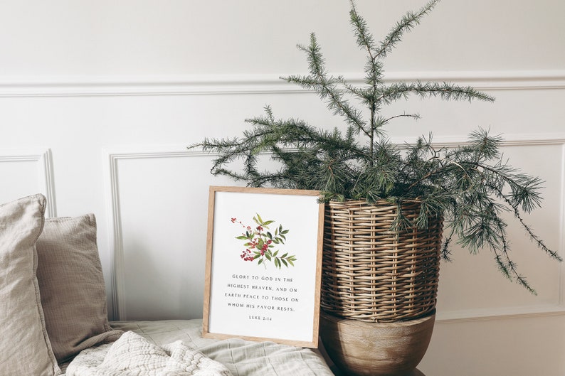 May include: A framed print with a watercolor illustration of a red berry branch and the text "Glory to God in the highest heaven, and on earth peace to those on whom his favor rests."  Luke 2:14