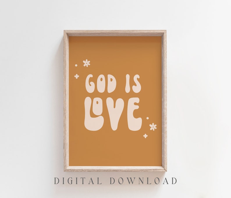 May include: A framed print with the words "GOD IS LOVE" in a retro font on a mustard-colored background. Small white flower and dot accents surround the text. The words "DIGITAL DOWNLOAD" are at the bottom.