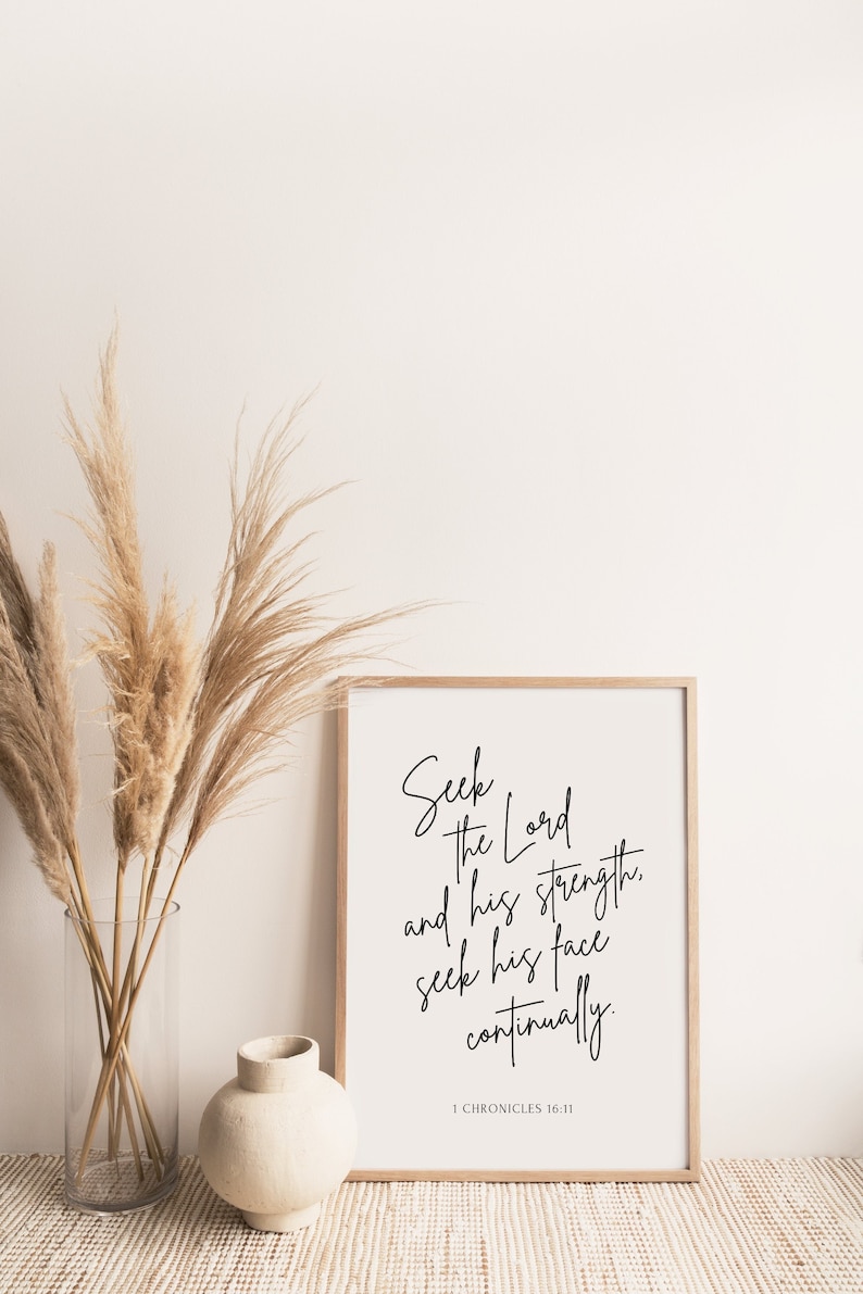 May include: A framed print with a white background and black text. The text reads "Seek the Lord and his strength. Seek his face continually." The bottom of the print has the text "1 Chronicles 16:11".