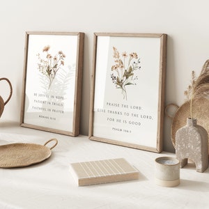 May include: Two framed art prints with botanical illustrations and inspirational quotes. The left print reads "Be Joyful in Hope, Patient in Trials, Faithful in Prayer, Romans 12:12." The right print reads "Praise the Lord, Give Thanks to the Lord, For He is Good, Psalm 106:1."