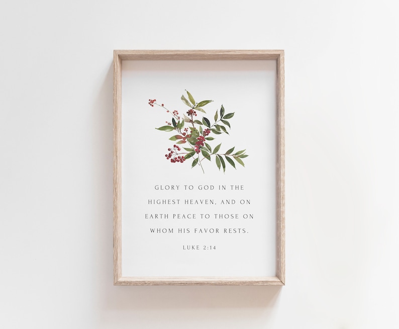 May include: A framed print with a watercolor illustration of a green plant with red berries. The print features the Bible verse "Glory to God in the highest heaven, and on earth peace to those on whom his favor rests."  Luke 2:14.