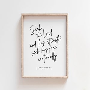 May include: A framed print with a black and white inspirational quote from the Bible: "Seek the Lord and his strength, seek his face continually." The quote is from 1 Chronicles 16:11.