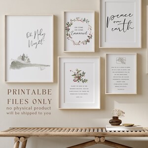 May include: Set of six printable Christmas art prints with a white background and a rustic wood frame. The prints feature a watercolor illustration of a forest, a wreath with red berries, a scripture verse, and the words "Oh Holy Night", "Peace on Earth", and "Oh Come Oh Come Emmanuel".