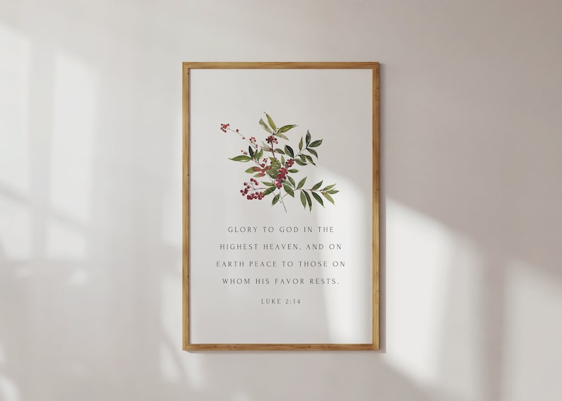 May include: A framed print with a watercolor illustration of a leafy branch with red berries. The print features the Bible verse "Glory to God in the highest heaven, and on earth peace to those on whom his favor rests."  Luke 2:14.