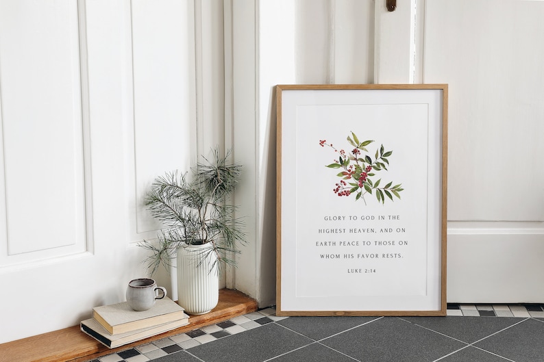 May include: A framed print with a watercolor illustration of a green plant with red berries. The print features the text "Glory to God in the highest heaven, and on earth peace to those on whom his favor rests. Luke 2:14".