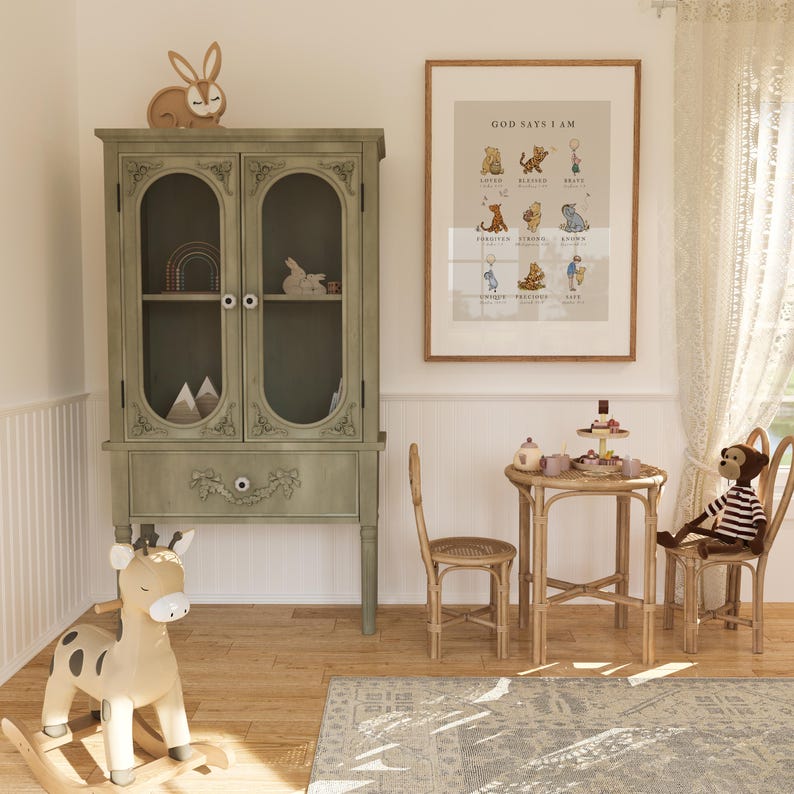 May include: A light green cabinet with glass doors and a drawer, a rocking giraffe toy, a small table and chairs, and a framed print with the text "God Says I Am" and illustrations of animals.