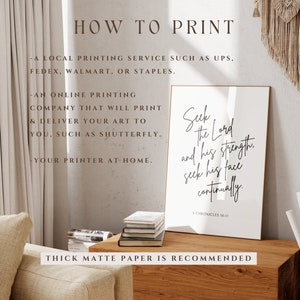 May include: A black and white printable wall art print with the text "Seek the Lord and his strength, seek his face continually. 1 Chronicles 16:11". The print is displayed on a wooden table with a beige sofa in the background.