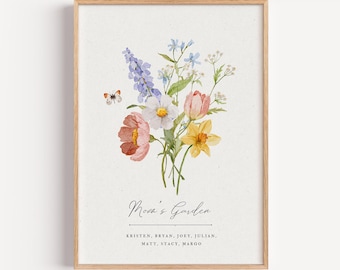 May include: A framed watercolor print featuring a bouquet of flowers in shades of pink, yellow, white, and purple, with a small butterfly. The text "Mosa's Garden" is written in cursive, with names listed below.