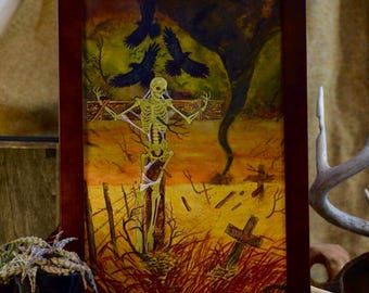 May include: A framed rectangular artwork featuring a skeleton bound to a wooden cross in a desolate landscape. The scene includes three black ravens flying above, a dark tornado in the background, and a small wooden cross in the foreground.