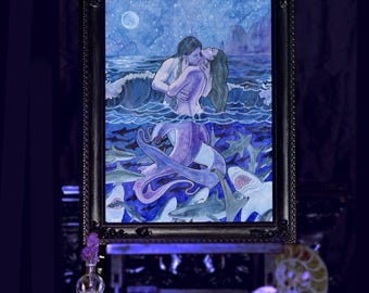 May include: A framed watercolor painting depicting a person embracing a mermaid in a moonlit ocean. The scene features a dark blue night sky with a full moon, rolling waves, and numerous sharks swimming beneath the surface in shades of blue and gray.