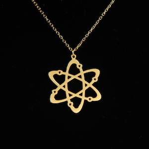 May include: A gold necklace with an atom pendant. The pendant is a simple, stylized design of an atom with a nucleus and orbiting electrons.
