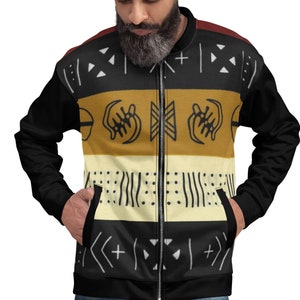 May include: A black bomber jacket with a zipper closure. The jacket features a colorful geometric pattern with black, white, yellow, and brown accents.