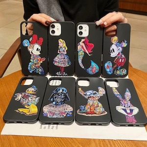 May include: Ten different phone cases featuring a variety of cartoon characters. The cases are black and showcase characters such as Mickey Mouse, Darth Vader, Stitch, and Bugs Bunny.