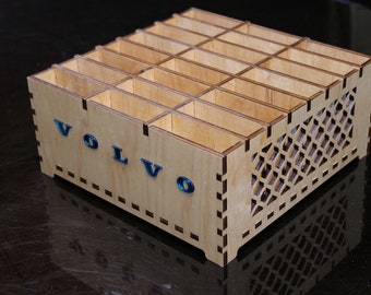 May include: A wooden organizer with 24 compartments, featuring a laser-cut design and the word "VOLVO" on the front.