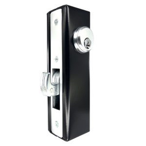 May include: Black rectangular door lock with a silver-colored latch and keyhole. The lock has a silver-colored faceplate and is mounted with silver screws. The lock is designed for security and access control.