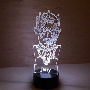 May include: A white acrylic night light with a 3D design of the Night King from Game of Thrones. The base of the light is black and has the name "Jerry" printed on it.