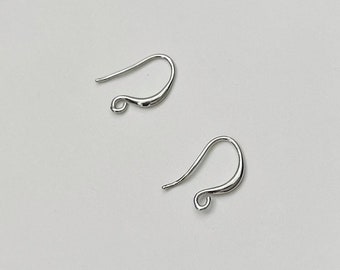 May include: Two silver earring hooks, a type of jewelry finding, are shown on a white background.