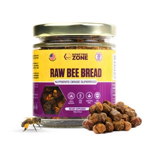 May include: A jar of "Raw Bee Bread" with a gold lid and a yellow and purple label. The label includes the text "Honeybee Zone" and "Nutrients Dense Superfood". A pile of bee bread and a bee are next to the jar. The jar contains 100g (3.5oz) of bee bread.