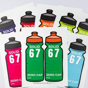 May include: A selection of water bottle stickers in shades of green, pink, blue, orange, and purple. Each sticker displays the word "SOLID" and the number "67" or the words "ZERO CAP". The stickers are presented against a white backdrop.