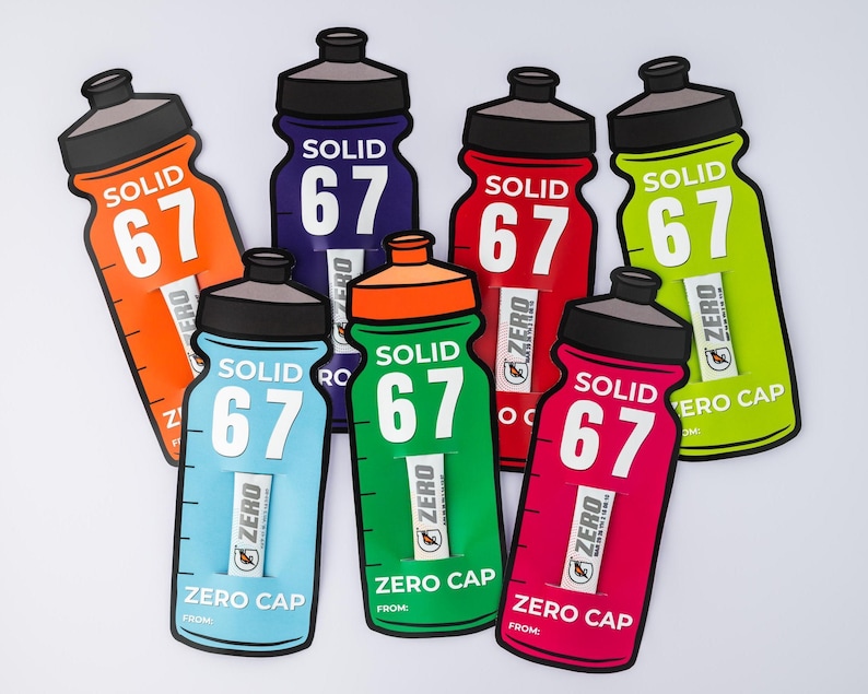 May include: A selection of water bottle-shaped cutouts in various colours. Each cutout displays the word "SOLID" above the number "67". The cutouts are in shades of orange, blue, green, red, and pink, with black caps and the text "ZERO CAP".