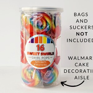 May include: A clear plastic container filled with 16 assorted swirl lollipops. The lollipops are red, yellow, orange, green, and blue. The container has a label that says "16 Sweet Swirls...Swirl Pops...Tutti Frutti". The text "Bags and Suckers Not Included! Walmart Cake Decorating Aisle" is written on a white background.