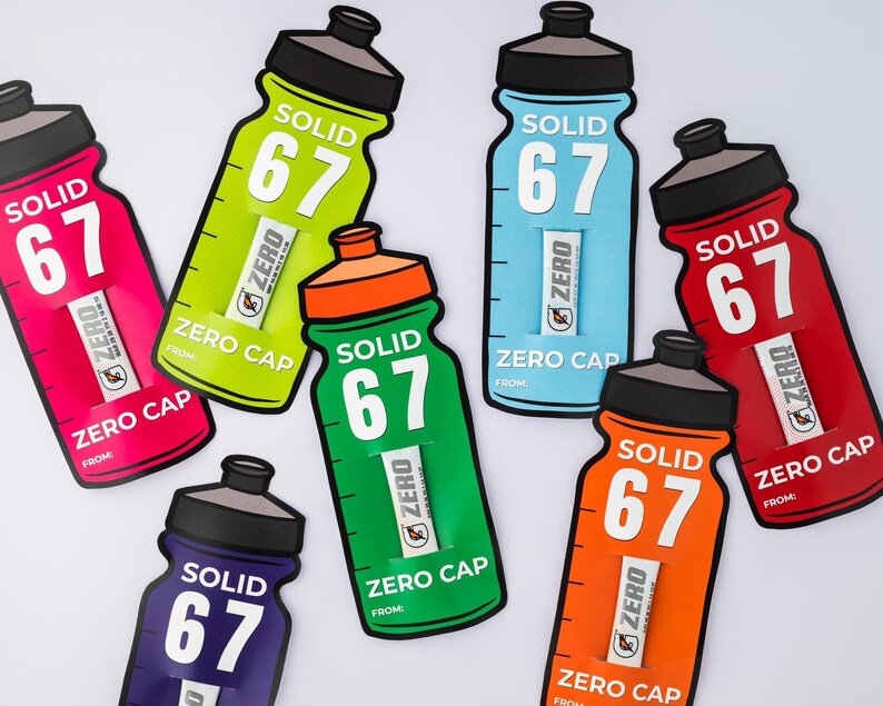 May include: A selection of water bottle-shaped cards in various colours. Each card displays the text "SOLID 67" and "ZERO CAP". The colours include pink, green, blue, red, orange, and purple. Each card also has a small insert.