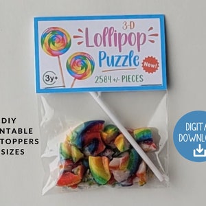 May include: A printable 3-D lollipop puzzle with 2584 pieces. The puzzle is in a clear plastic bag with a white stick. The bag has a label that says "3-D Lollipop Puzzle" and "New!" with a red star. The label also says "3y+" and "2584+/- PIECES". The bag is on a white background. DIY Printable Bag Toppers 5 Sizes. Digital Download.