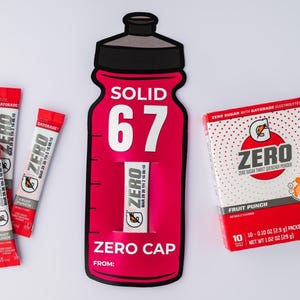 May include: A display of Gatorade Zero products. Includes a red and black bottle-shaped cutout with the text "SOLID 67" and "ZERO CAP", packets, and a box of Fruit Punch flavour. The box contains 10 packets, each 2.9g.