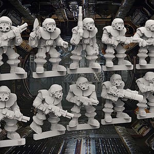 May include: A collection of gray miniature figurines of futuristic soldiers, each equipped with helmets, respirators, and weapons. The figures are posed in various stances, suggesting action and combat. The overall theme is science fiction or tabletop gaming.