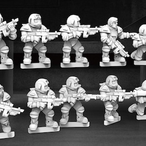 May include: A collection of ten miniature figurines of soldiers in futuristic armor, each holding a rifle. The figures are in various poses, standing and kneeling, and are mounted on rectangular bases. The overall color scheme is a monochromatic grayscale.