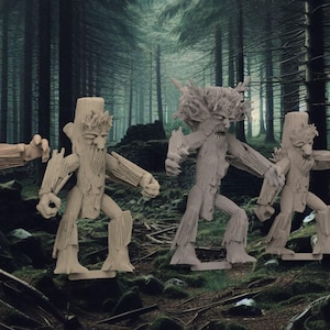 May include: Five wooden figurines of tree creatures with gnarled branches and faces. The figures are standing in a forest setting.