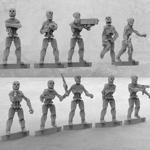 May include: A set of ten gray plastic skeleton figures, each with a different pose and holding a weapon. The figures are standing on a gray surface.