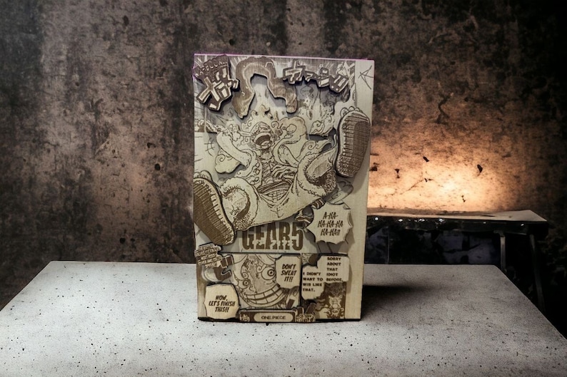 May include: A wooden cutout of a manga character with the text "GEAR 5" and "ONE PIECE" in the bottom right corner. The character is in a dynamic pose with a large, exaggerated hand and a determined expression. The cutout is made of light brown wood and has a textured surface.