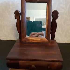 A small handmade dressing table mirror with drawer