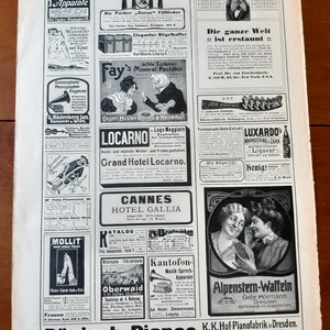 May include: A vintage magazine advertisement featuring various products, including a fountain pen, a suitcase, a mineral tablet, a phonograph, a hotel, a piano, a waffle iron, and a bottle of liqueur. The magazine ad is printed in black and white.