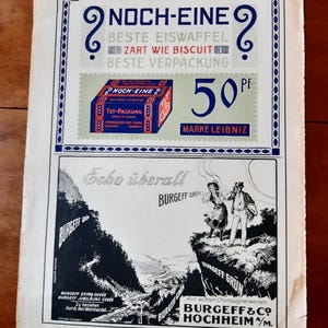 May include: A vintage advertisement for Burgeff & Co. Hochheim/M. wine. The ad features a black and white illustration of a couple standing on a cliff overlooking a valley. The text reads "Echo &uuml;berall Burgeff Gr&uuml;n" and "Aus echten Champagnerweinen. Burgeff & Co. Hochheim/M."