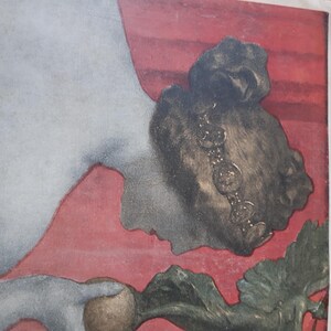 May include: A vintage illustration of a woman with dark hair and a beaded necklace, lying on a red background. She is holding a large, brown turnip in her hand. The image is from a magazine with the text "Heft. XXIII. Jahrgang" printed on the right side.