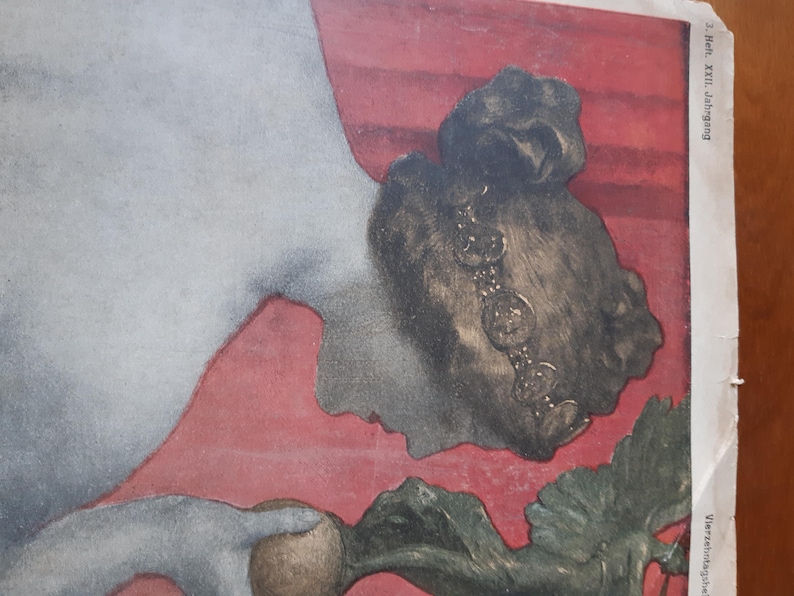 May include: A vintage illustration of a woman with dark hair and a beaded necklace, lying on a red background. She is holding a large, brown turnip in her hand. The image is from a magazine with the text "Heft. XXIII. Jahrgang" printed on the right side.