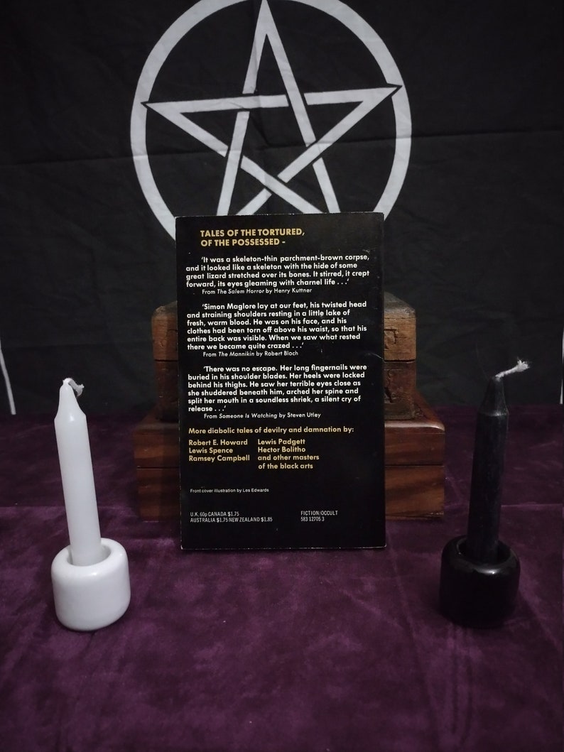 May include: A book cover with a black background and a white pentagram. The book title is "Tales of the Tortured, of the Possessed". The book cover features an excerpt from the book and a list of authors.