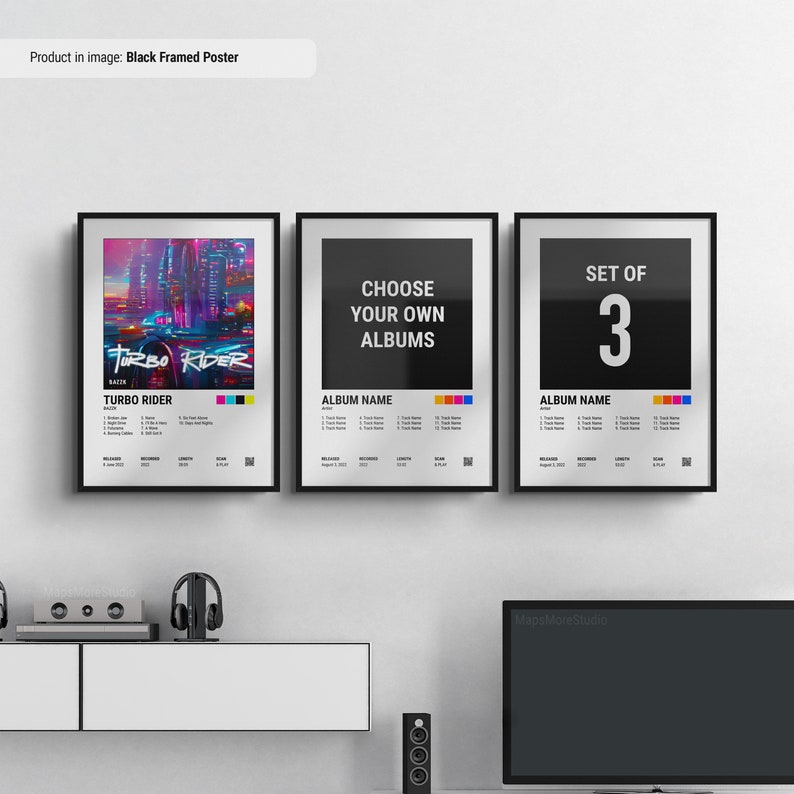 May include: Three black framed posters with album covers. The left poster features a colorful illustration of a futuristic city with a car driving through it. The text "TURBO RIDER" is in the center of the poster. The middle poster has the text "CHOOSE YOUR OWN ALBUMS" and the right poster has the text "SET OF 3".