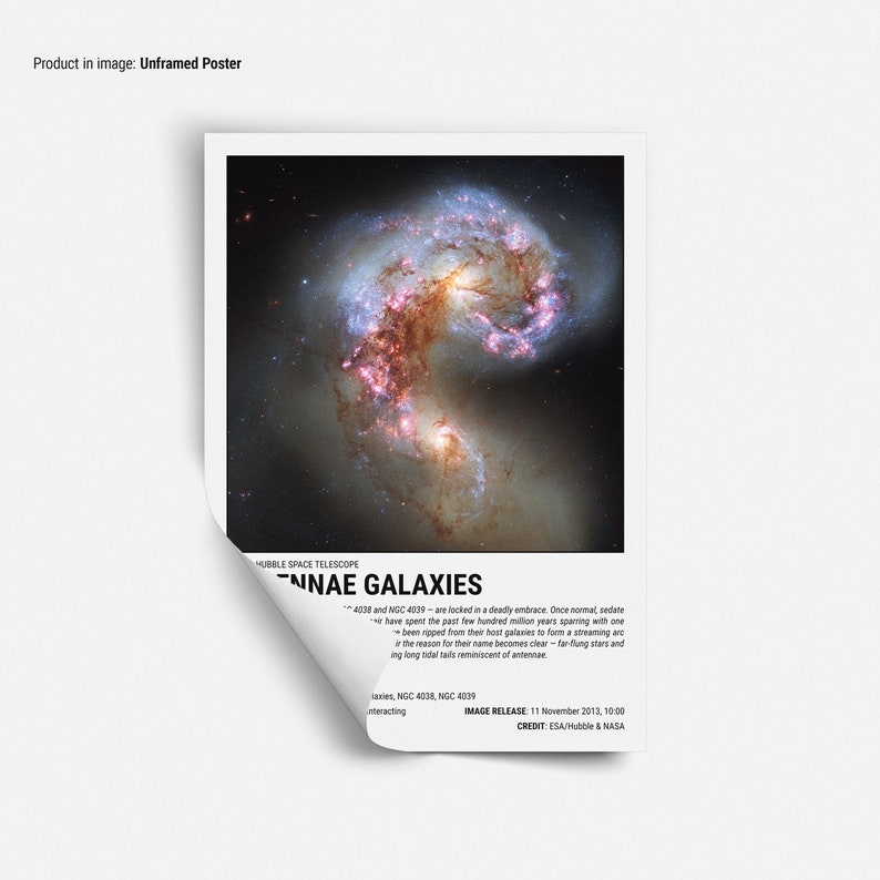 May include: Unframed poster featuring a vibrant image of the Antennae Galaxies, captured by the Hubble Space Telescope. The image showcases two interacting galaxies with swirling arms of stars and gas, in shades of red, orange, and blue. Text includes "Antennae Galaxies".