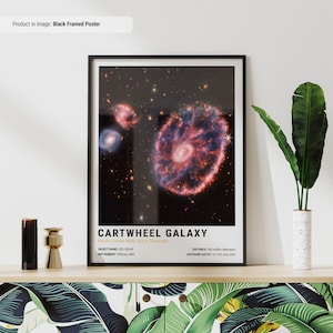 May include: A black framed poster with a colorful image of the Cartwheel Galaxy, taken by NASA's James Webb Space Telescope. The poster includes the text "Cartwheel Galaxy", "NASA's James Webb Space Telescope", "OBJECT NAME: ESO 350-40", "INSTRUMENT: NIRCam, MIRI", "DISTANCE: 500 million light years", and "EXPOSURE DATES: 10-11th June 2022".
