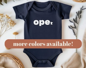 May include: A dark navy blue short-sleeved baby bodysuit featuring the white text "ope" with the letter "e" stylized as the outline of the state of Minnesota. The garment has a crew neckline and a snap closure at the bottom crotch area.