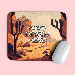 May include: A desert landscape with a cactus and rocks, a mouse pad with the text "YOUR DESIGN HERE" printed on it, and a white computer mouse.