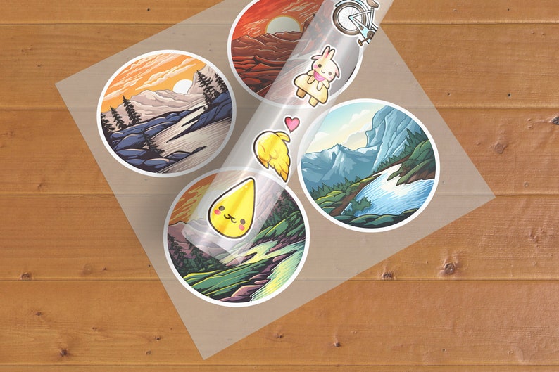 May include: A sheet of clear sticker paper with five stickers. The stickers are round and feature colourful illustrations of landscapes and a cartoon character. One sticker shows a mountain range with a river flowing through it. Another sticker shows a sunset over a mountain range. A third sticker shows a cartoon character with a heart above its head. The fourth sticker shows a cartoon character with a yellow drop of liquid above its head. The fifth sticker shows a cartoon character with a yellow drop of liquid above its head.